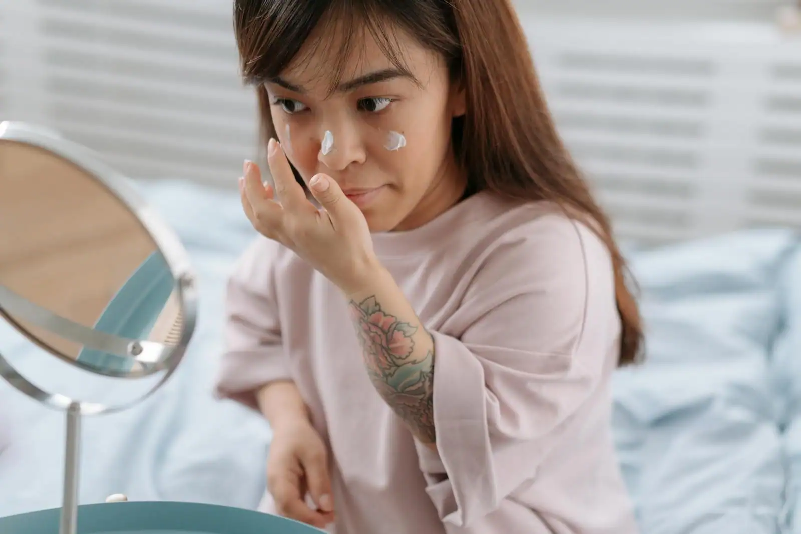 Femme appliquant une crème hydratante sur son visage